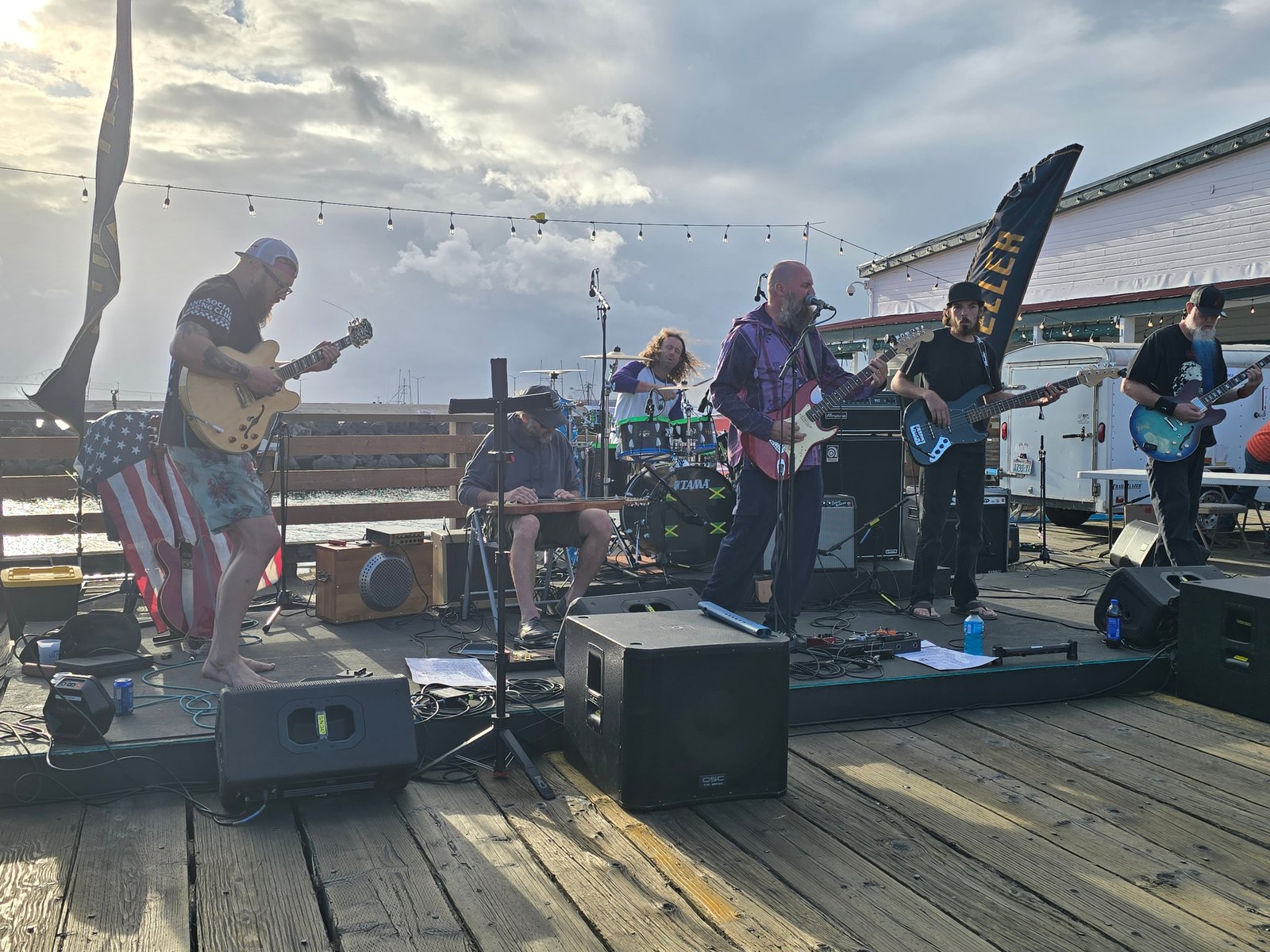 Midnight Cove performing live on a pier stage at Rigs & Reggae, Astoria OR